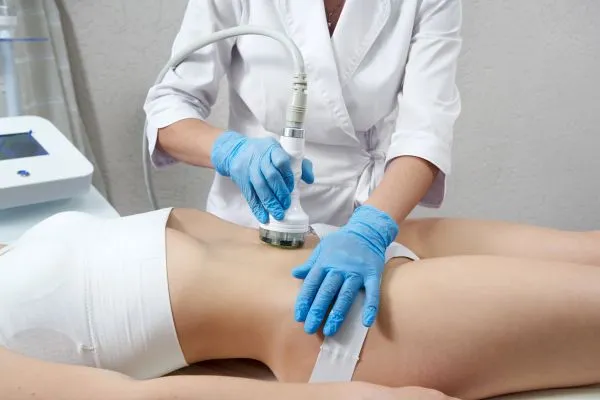 Lost the Weight but Not the Loose Skin? 2 woman having HIFU treatment on her stomach to combat loose skin Elstree following weight loss